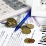 Calculator and Euro bills with pen on european electricity bill